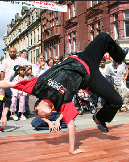 A picture of a guy doing a handstand with one hand