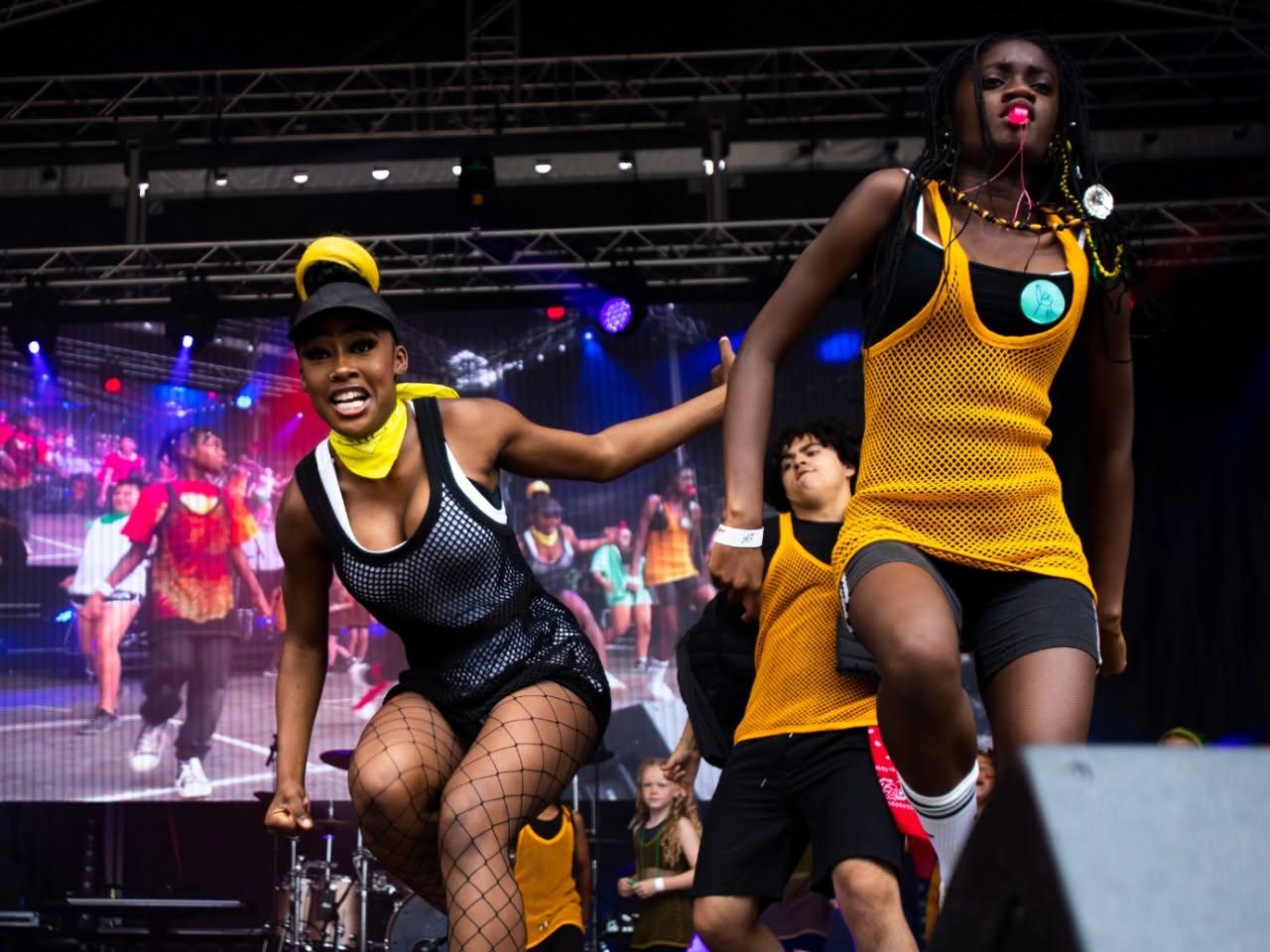 A picture of 2 girls performing a dance on stage