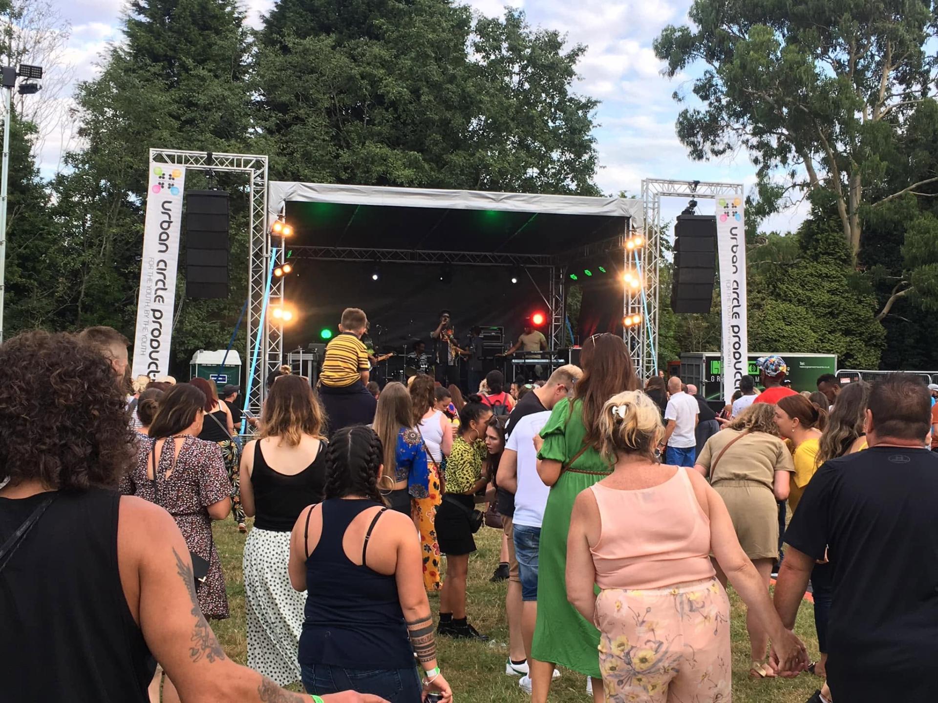 A picture of a stage from one of our music events from within the crowd