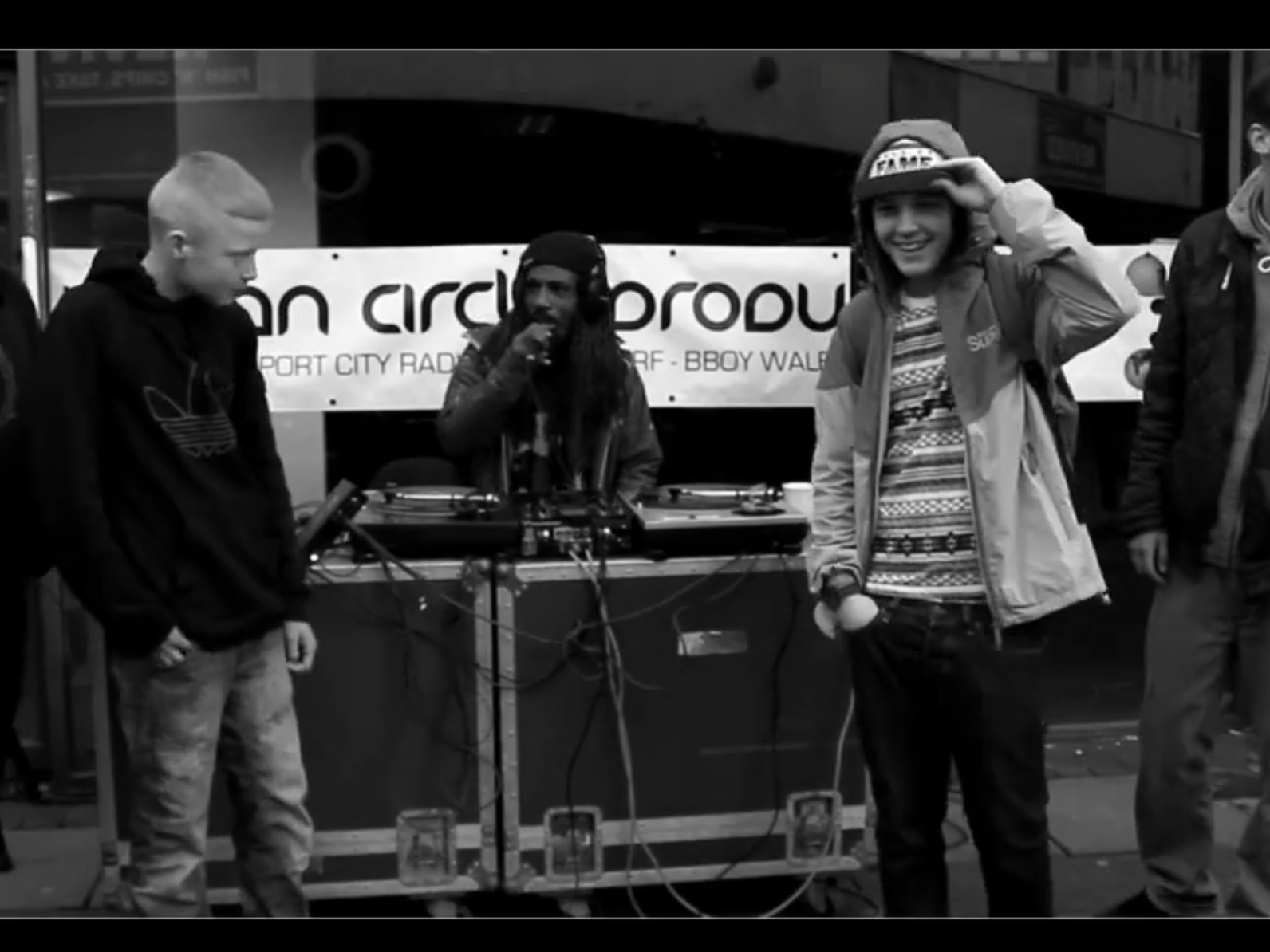 A picture of kids around some DJ Decks manned by Akil the Emcee during a rap cypher