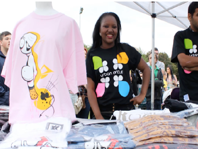 A picture of some volunteers manning a merch stall during Pill Carnival