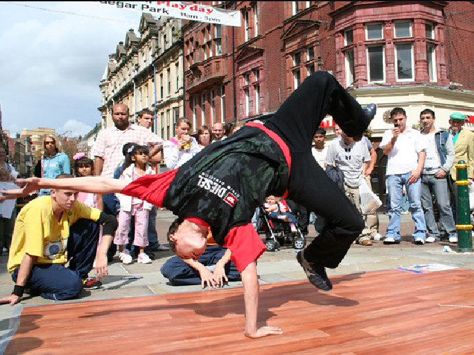 A picture of a guy doing a handstand with one hand